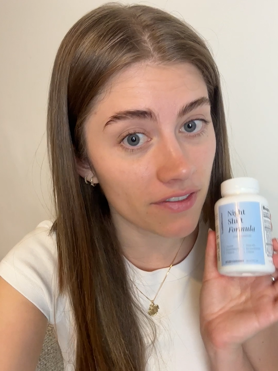 Robin holding a bottle of Night Shift Formula cognitive support supplement